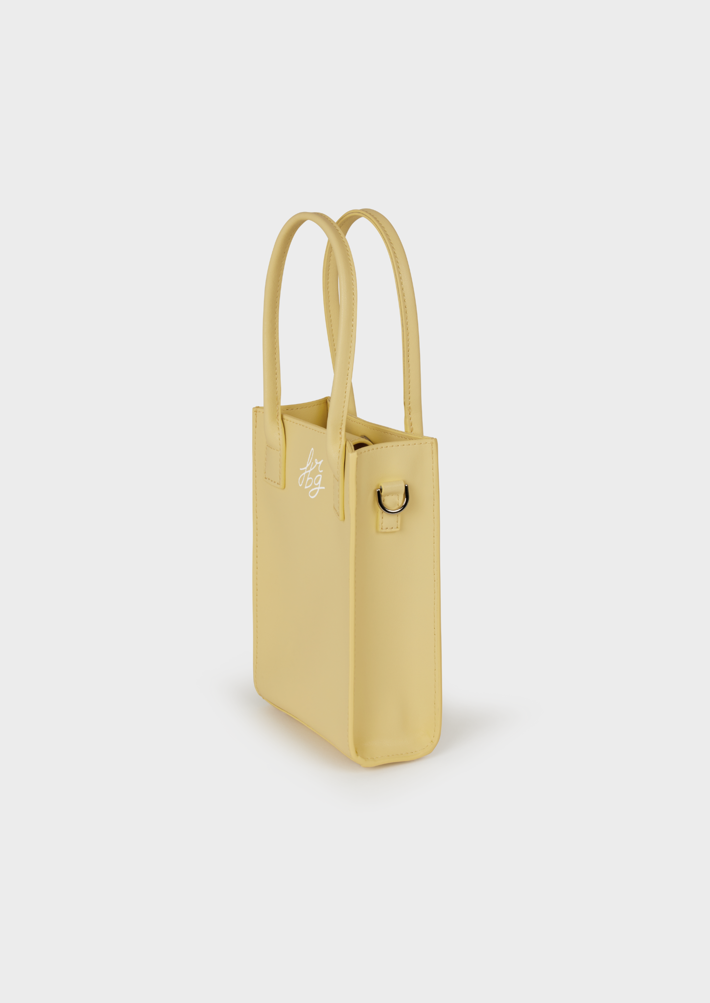 Petit sac jaune pastel en cuir, avec bandoulière et attache métallique