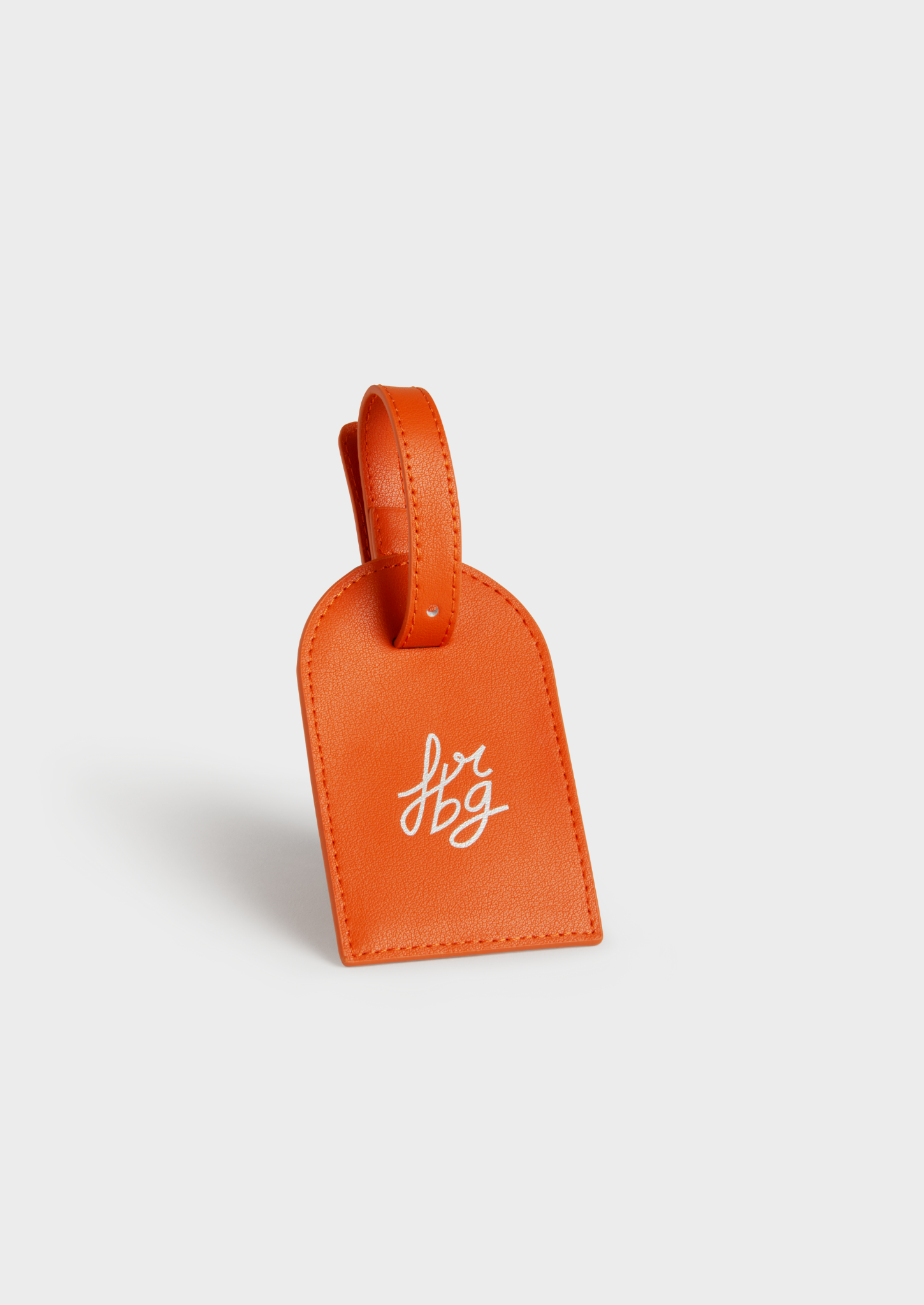 Porte-étiquette de bagage orange en cuir, avec logo argenté "frbg"