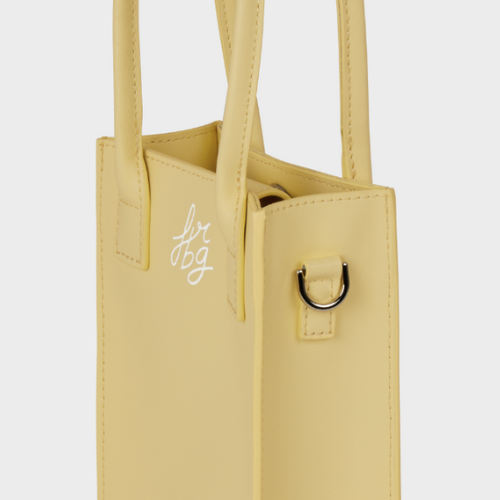 Petit sac jaune pastel avec poignées doubles et logo blanc "fbg"