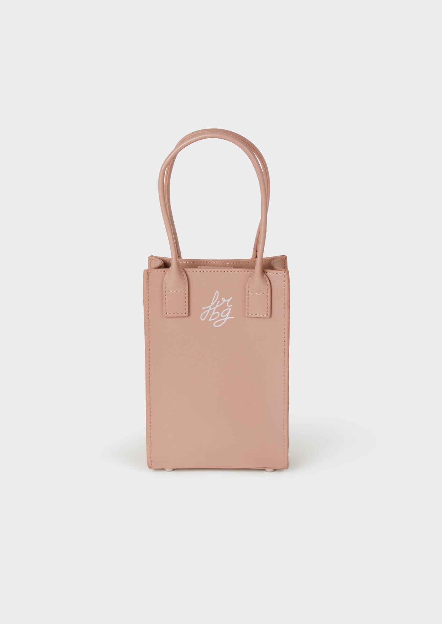 Un sac à main rectangulaire rose clair avec deux poignées 